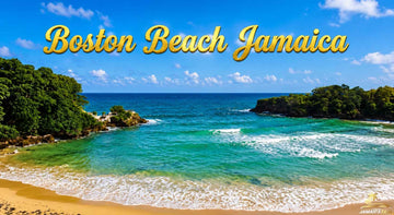 Boston Beach Jamaica with turquoise Caribbean waters, golden sandy shore, lush green cliffs, and waves beneath a bright blue sky.
