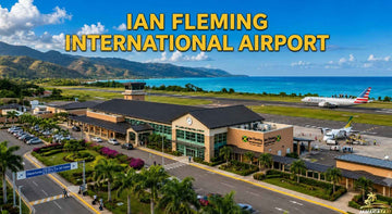 Ian Fleming International Airport aerial view with terminal, runway, aircraft, turquoise coastline, and lush Jamaican mountains.