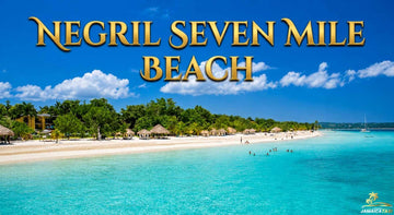 Negril Seven Mile Beach Jamaica with turquoise Caribbean water, white sand, palm trees, and a bright blue tropical sky.